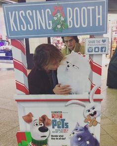 an advertisement for the movie's kissing booth is displayed in front of a store