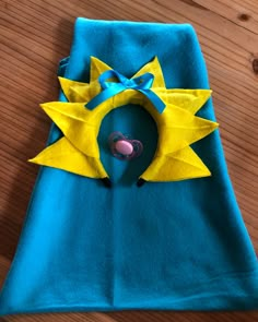 a blue towel with a yellow sun on it and a pink heart in the center