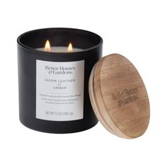 a black candle with a wooden lid next to it