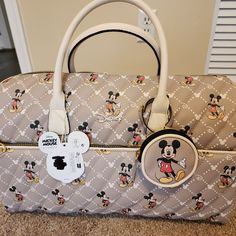 This Disney Weekender Bag Is An Essential For Any Disney Fan! With A Stylish Design And Ample Space, This Bag Is Perfect For Weekend Getaways Or As A Carry-On For Your Next Flight. The Bag Features The Iconic Disney Franchise And Is Made With High-Quality Materials To Ensure Durability. In Addition To Its Spacious Interior, The Bag Also Has Multiple Pockets For Easy Organization Of Your Belongings. Whether You're A Collector Of Disney Merchandise Or Simply A Fan Of The Franchise, This Bag Is A M Disney Bags For Daily Use, Themed Bags With Character Print For Disney Trips, Disney White Travel Shoulder Bag, Disney Travel Bags With Detachable Strap, Disney Rectangular Travel Bag, Mickey Mouse Purse, Cute Mickey Mouse Bags For Travel, Disney Luggage, Paw Wallpaper