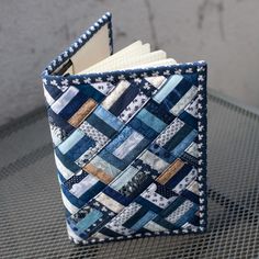 a blue and white quilted book holder