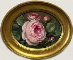 a painting of pink roses in a gold frame