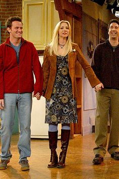 two men and a woman are holding hands