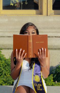 a woman holding two books in front of her face