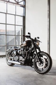 a black motorcycle parked in front of a window