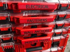 red and black plastic drawers with electrical fasteners written on each drawer in front of them