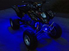 an atv is lit up with blue lights