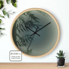 a clock that is on the wall next to a potted plant and some plants