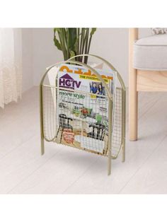 a magazine rack with magazines on it next to a chair