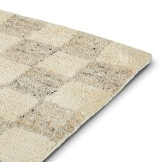 an area rug is shown with squares and dots on the carpet, as if it were made out of wool or polyester