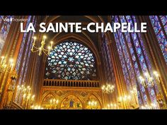 the inside of a cathedral with chandeliers and stained glass windows in front of it