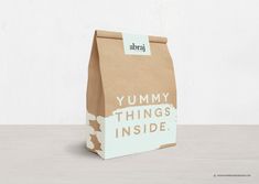 a paper bag with the words yummy things inside on it sitting on a table