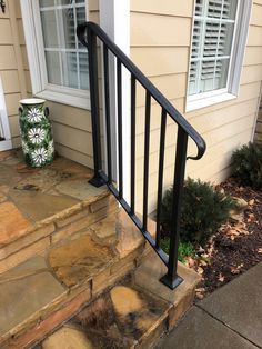 a black hand rail on the side of a house