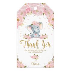 a pink and gold baby shower tag with an elephant in the center, surrounded by flowers