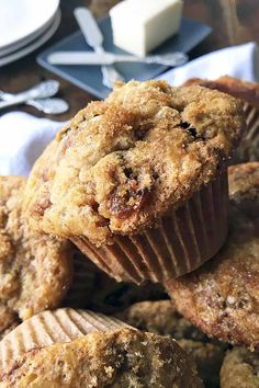 muffins piled on top of each other with butter and chocolate chips in the background