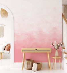 a pink and white painted room with two stools next to a table on the floor