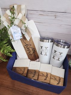 the gift box contains four personalized tumblers and two wrapped gifts