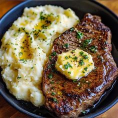 steak and mashed potatoes in a black bowl