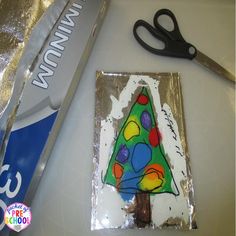 a cake with a christmas tree on it next to scissors