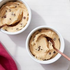 two white bowls filled with peanut butter and chocolate chip ice cream on top of a table