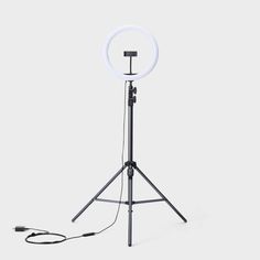 a tripod light with a white ring on it