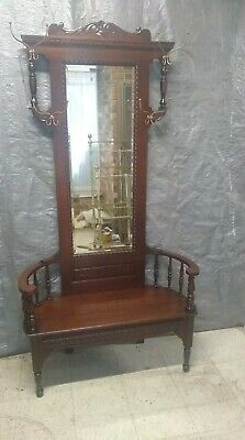 an antique wooden bench with mirror on it