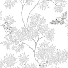 two owls sitting on top of a tree next to leaves and flowers in black and white