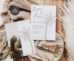 the wedding stationery is laid out on a wooden table with two photos and an old pair of scissors