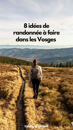 a person walking down a dirt path in the mountains with text overlay that reads 8 idees de randonnee d'faire dans les voges