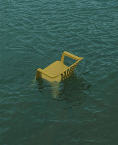 a yellow object floating on top of water