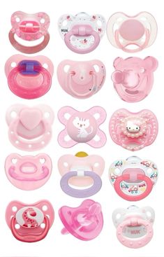 many different types of baby pacifiers and bibs in pink, white and blue