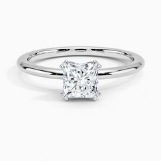 a princess cut diamond engagement ring on a white background with the band around it's edge