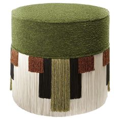 a green and white stool with tassels on it