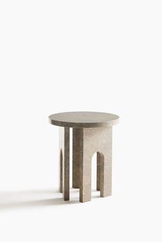 a round table with two legs and a small circular table on one end that is made out of concrete