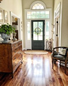 a living room with hardwood floors and a door that leads to the front porch area