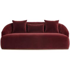 a red velvet couch with four pillows on it's back and two sides, in front of a white background