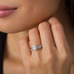 a woman's hand with a diamond ring on her finger