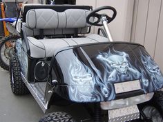 a black and white golf cart with skulls on it