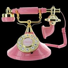 an old fashioned pink and gold rotary phone