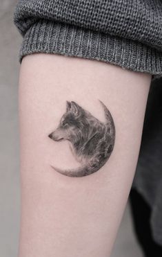 a small wolf tattoo on the right thigh