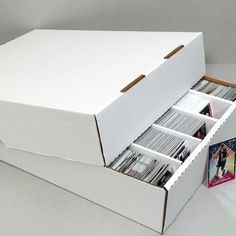 an open white box with several records in it and a card catalog inside the lid