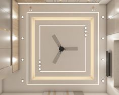 a ceiling fan in the middle of a room with white walls and lights on it