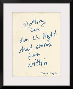 a handwritten quote on white paper with blue ink in the center and black frame