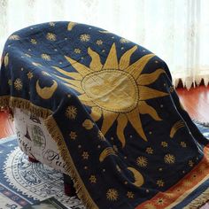 a sun and moon blanket on top of a rug