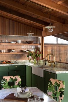 an image of a kitchen setting with green cabinets