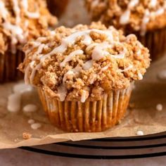 several muffins with crumbs sitting on a table