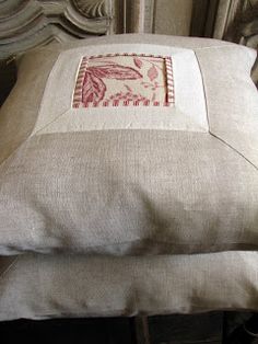 two pillows sitting next to each other on top of a chair