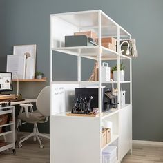 an office with a desk, chair and computer on the shelf in front of it