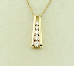 "Vintage graduating round brilliant diamonds in a 14K yellow gold pendant symbolize love grows each day. This classic yesterday, today and tomorrow pendant is the perfect way to show her your feelings. Free domestic shipping! Details: Solid 14K Yellow Gold: (as shown in picture) Natural Diamond: (1) 4.5, (1) 4.2 mm, (1) 4.0 mm, (1) 3.7 mm round Approximate Total Diamond Weight: 1 carat Diamond Color: G Diamond Clarity: SI Pendant Dimensions: 1 inch x 3/8 inch Total Weight (together): 5.5 grams F 14k Gold Diamond Necklace For Anniversary, Yellow Gold Diamond Necklace For Anniversary, Channel Set Diamond Necklace, Diamond Pendant Sets Unique, Ruby Jewelry Necklaces, Diamond Pendants Designs, Diamond Earrings Design, Diamond Pendant Sets, Jewelry Illustration