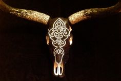 an animal's skull is adorned with white and silver beads on it's long horns